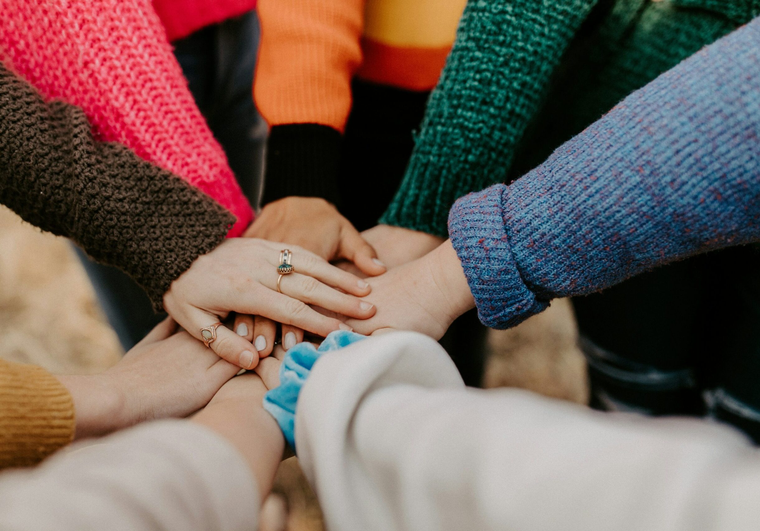 Multiple hands in a huddle