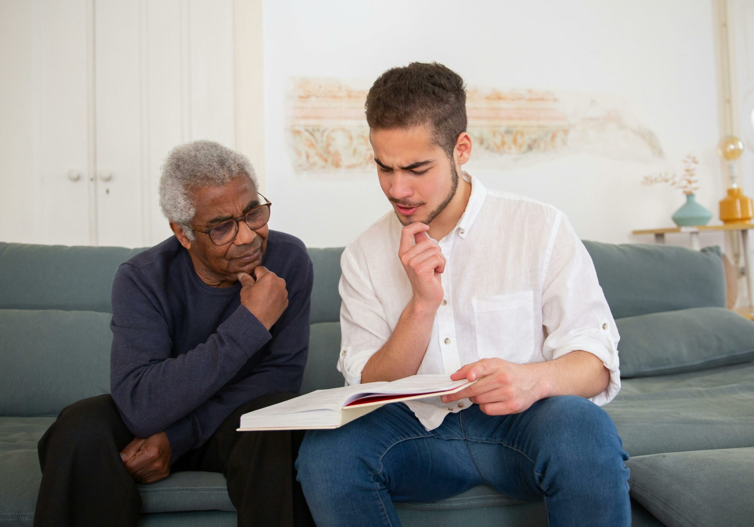 Two men reading a book